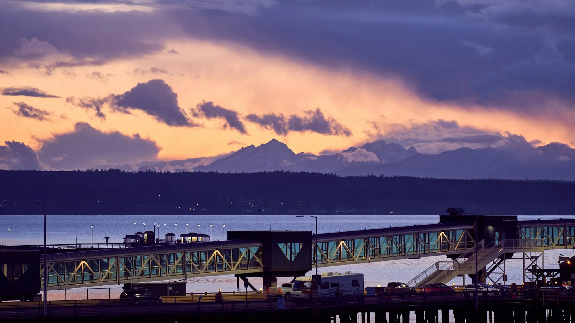 The Olympic Mountains at sunset beyond the Edmonds waterfront and ferry dock