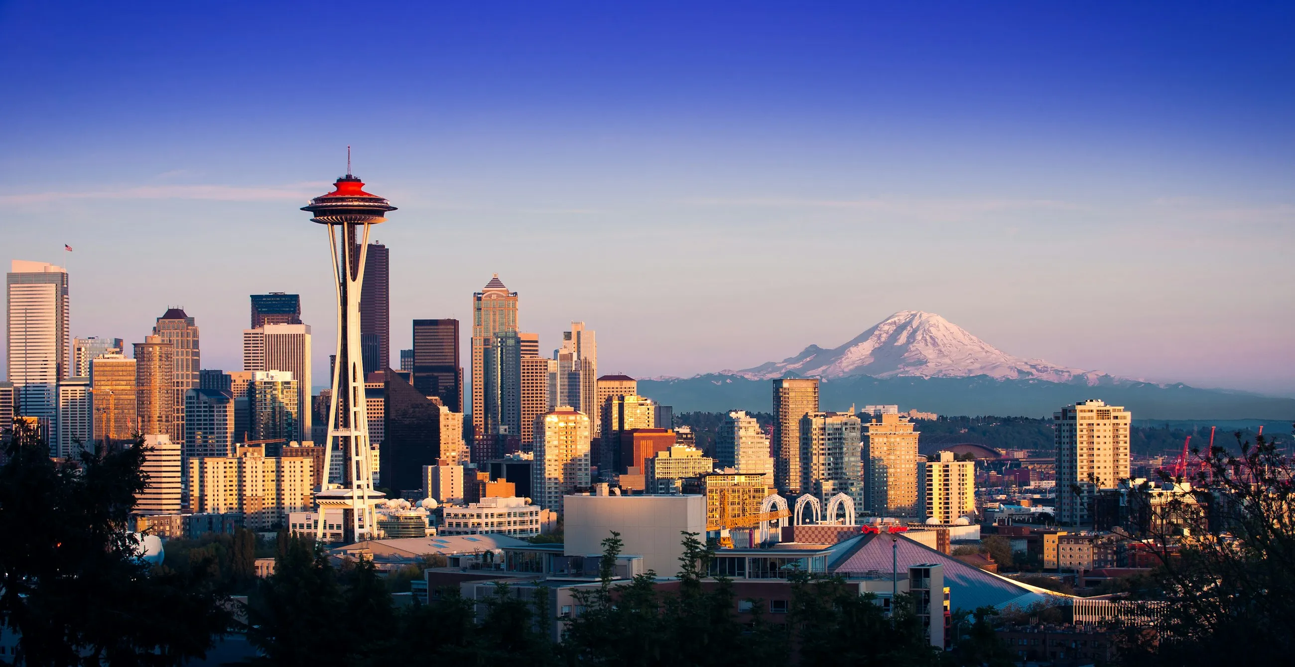 Seattle skyline and the Space Needle at golden hour with Mount Rainier rising in the distance